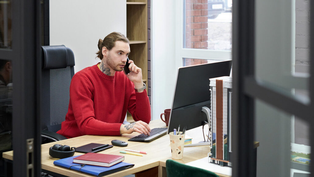 A man with a computer in his office working remotely to troubleshoot computer and server errors via the Managed Activation Platform.